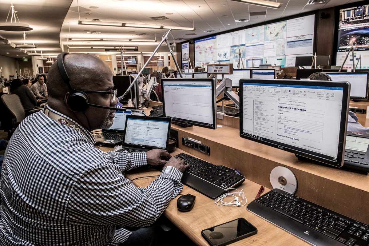 Badass Logistics dispatcher planning loads, routes and rates at a multi-monitor desk