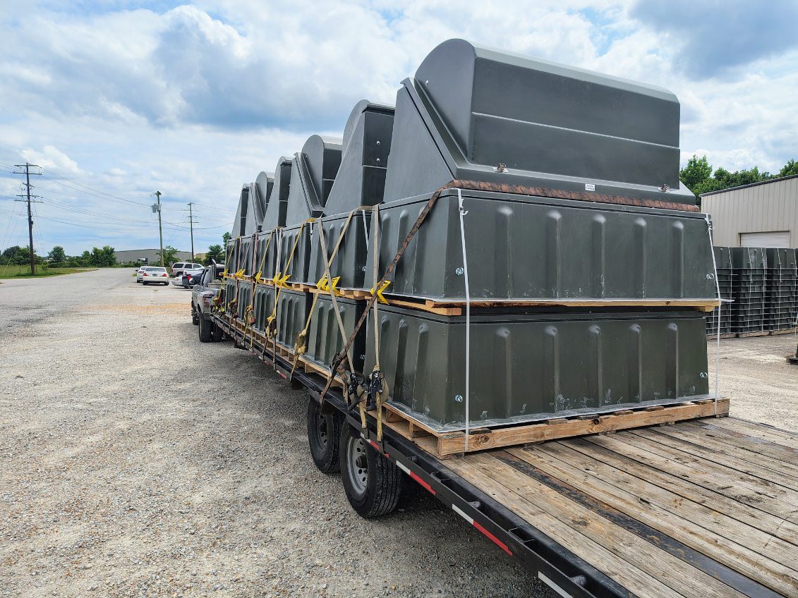 Large industrial equipment secured on a flatbed trailer during a staged plant relocation
