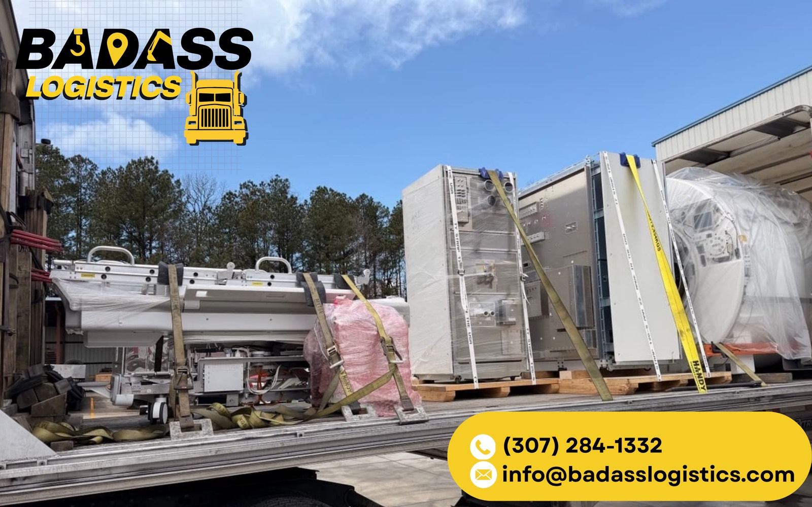 Crated HVAC and industrial equipment strapped on a Badass Logistics flatbed