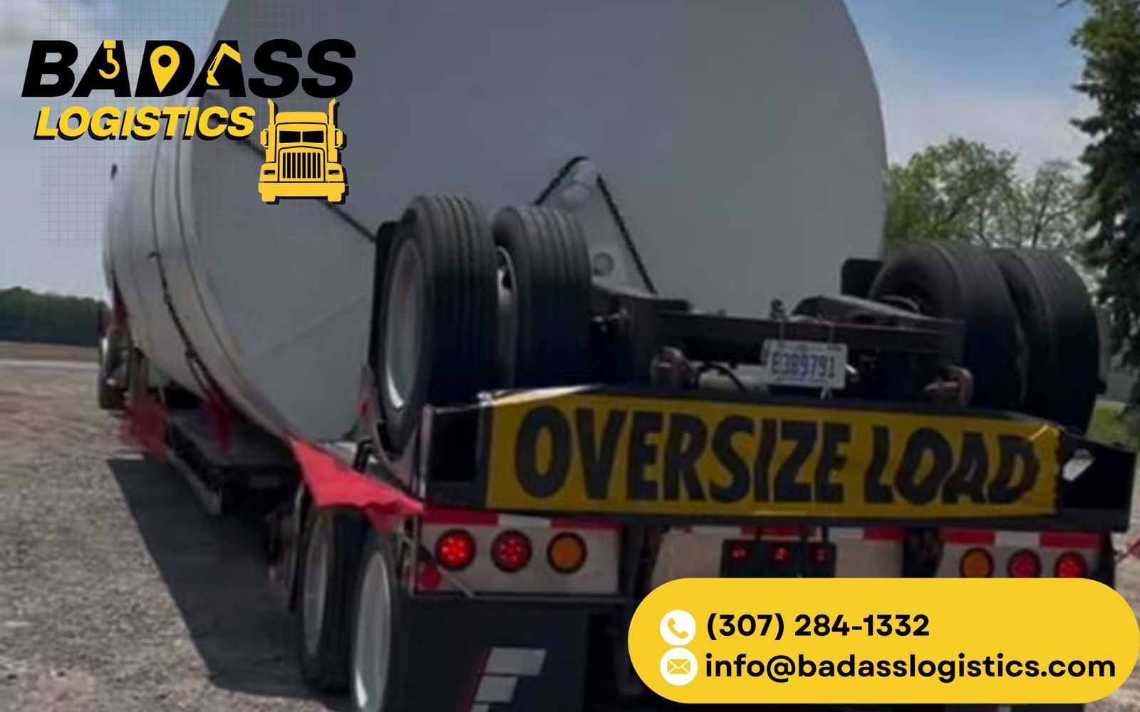 Oversize load — large tank hauled on a red lowboy trailer by Badass Logistics