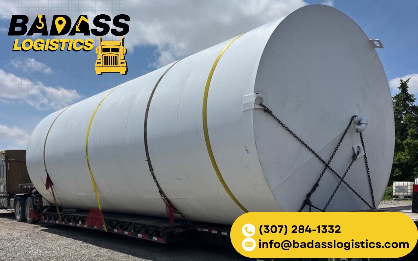 Oversized storage tank chained on a step-deck for heavy haul transport