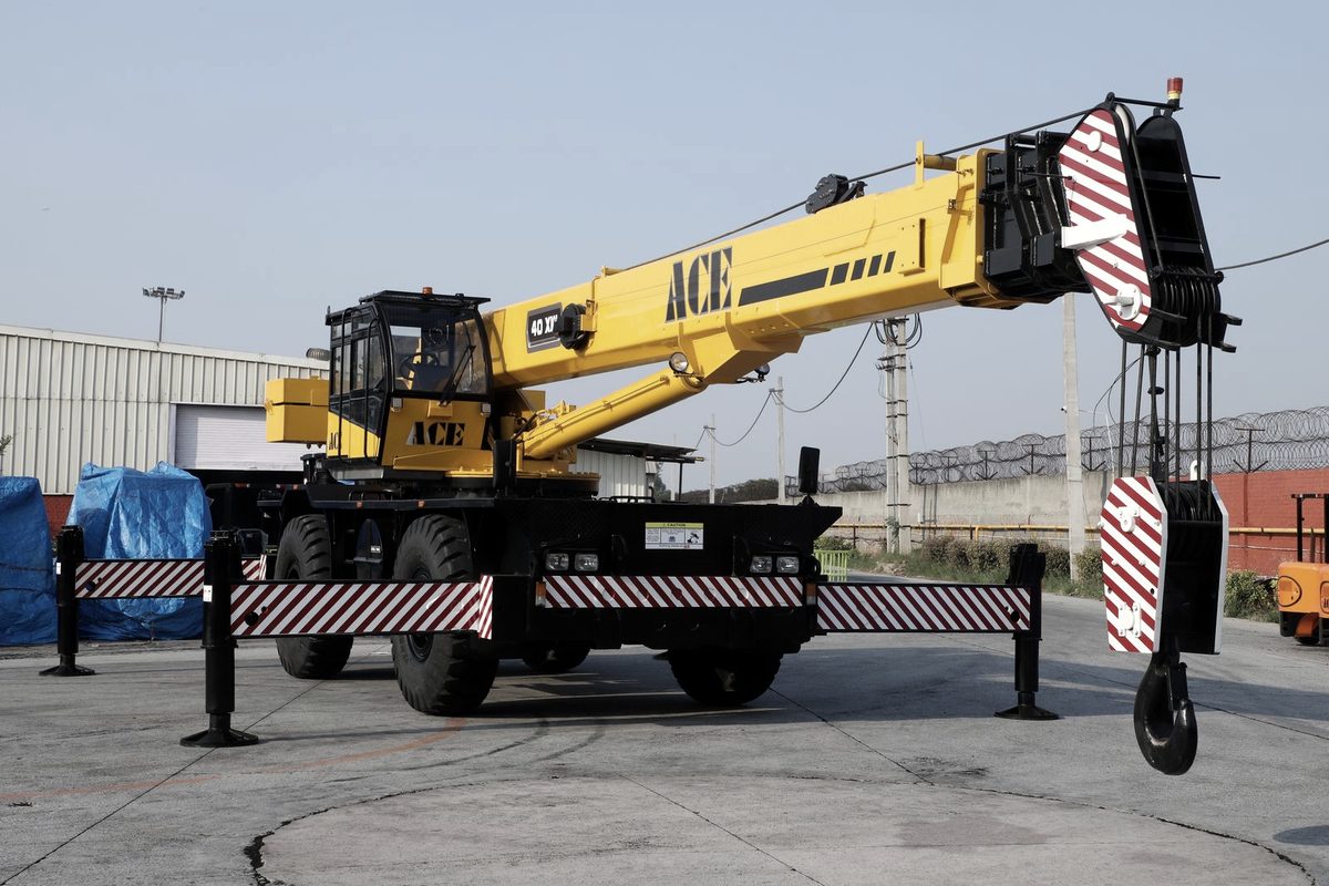 Crane and rigging crew lifting industrial machinery during a machine move